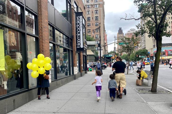 yellow balloons on a sidewalk